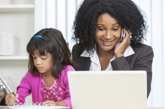 mom works from home alongside remote learning daughter