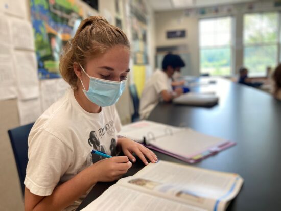 teenage girl learns in the classroom at ISI