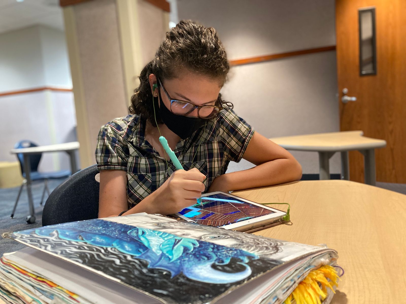 Young girl does classwork at ISI