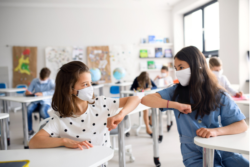 Classmates bump elbows to stay safe from COVID19