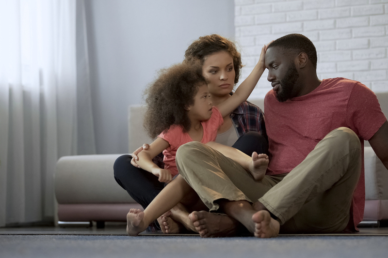 little girl feels daddy's forehead