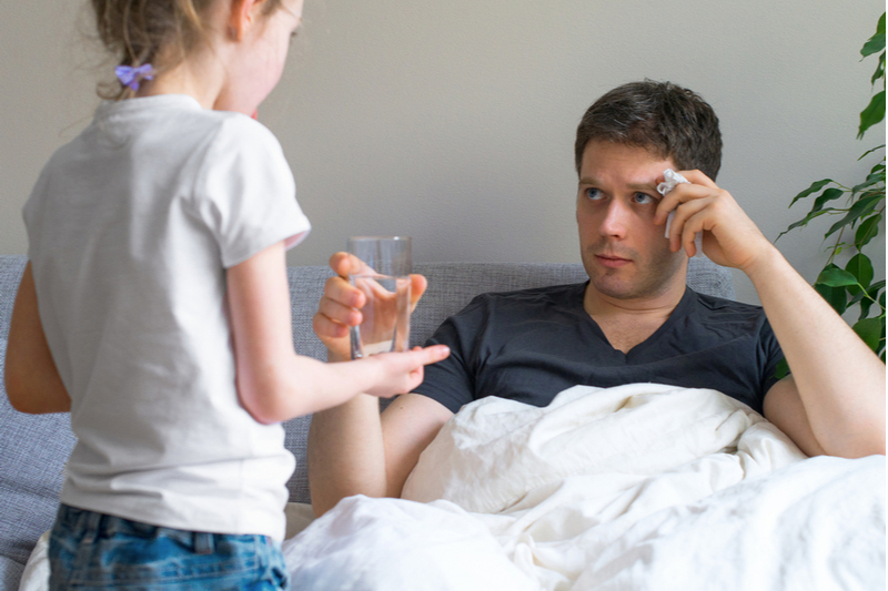 little girl takes empty glass from sick dad