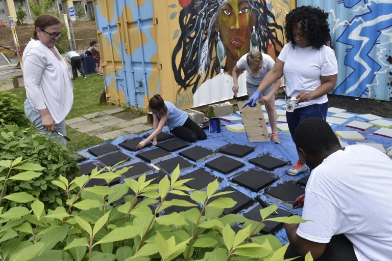 A family workshop at an outdoor community garden in Braddock, PA. (Photo credit: Ben Filio)