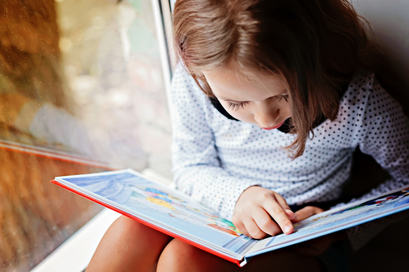 Girl works hard to read a book