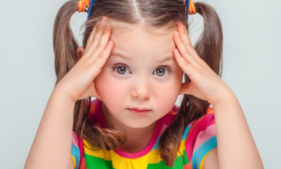 Little girl hold head represents expressing frustration over language disorders