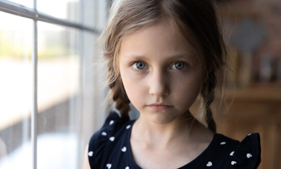 Serious girl uses facial expressions instead of words because of language disorders