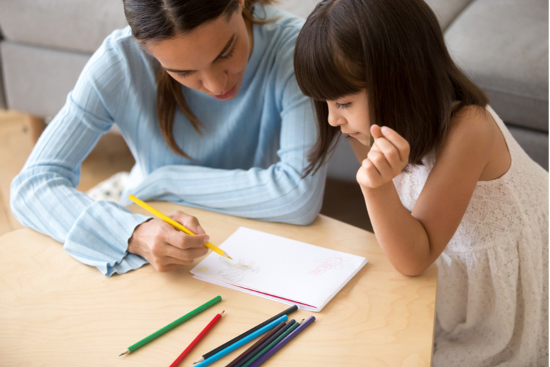 therapist works with little girl who has language disorders