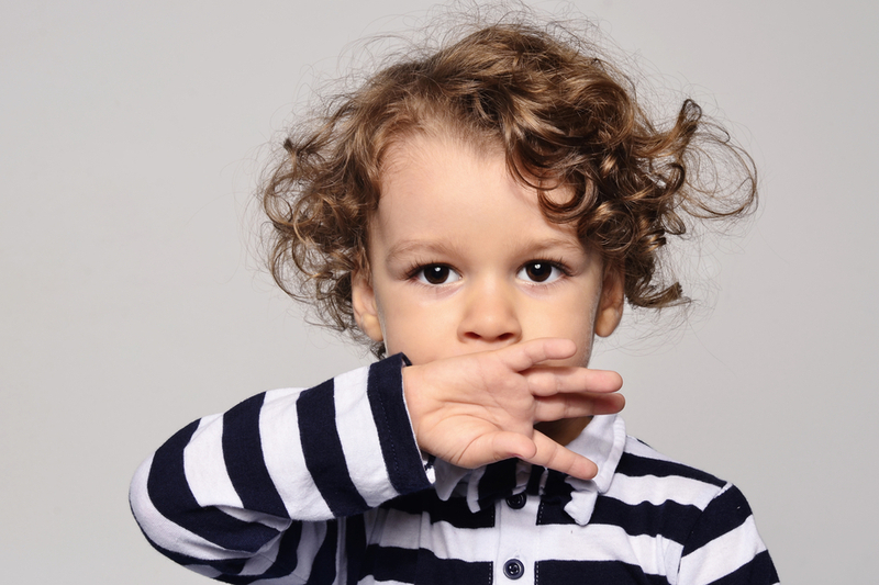 toddler holds hand over mouth represents language disorders