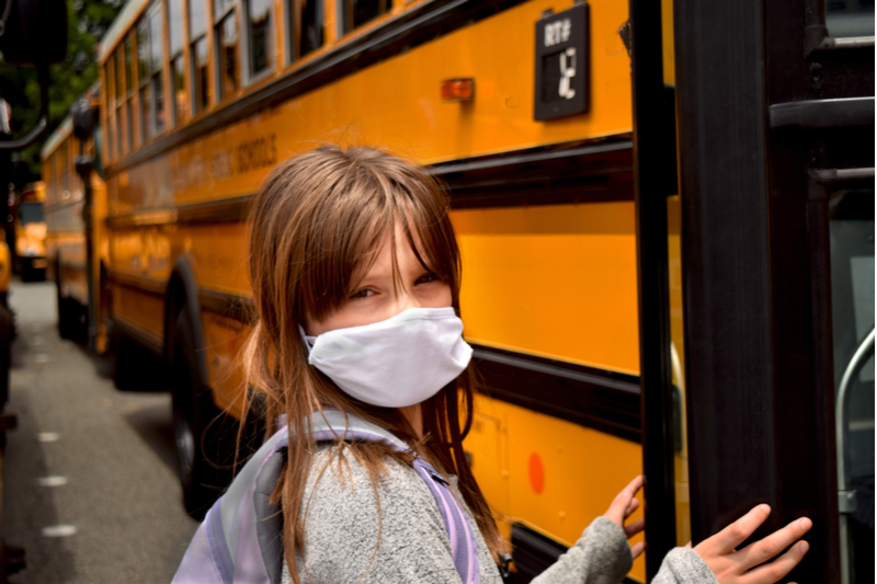 girl facing back to school fears ahead of boarding bus