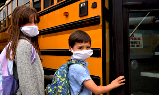 masked students board school bus with back to school fears