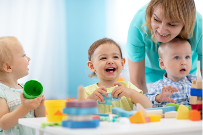 pandemic babies play with teacher in day care