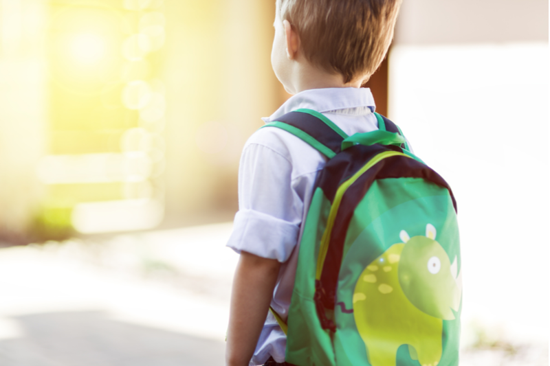 Kindergartener with backpack reluctant may need grade retention