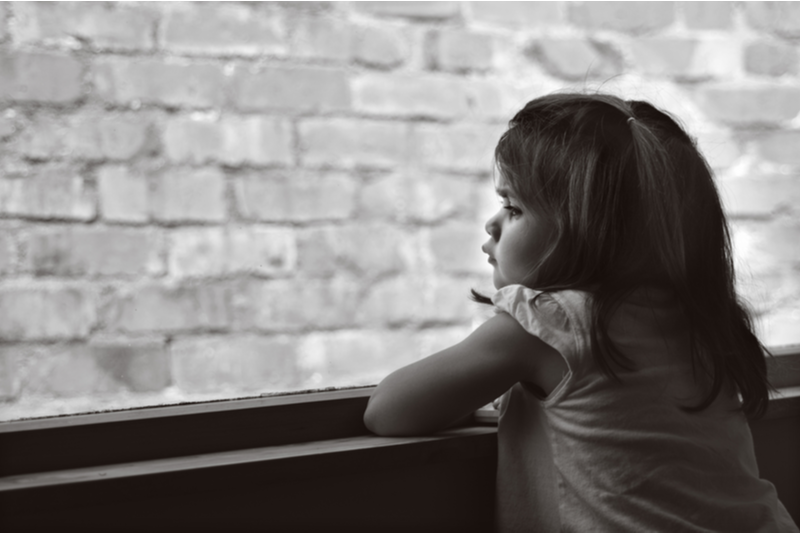 8 year old girl with autism diagnosis looks out of window