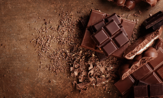 broken up chocolate bars against brown background