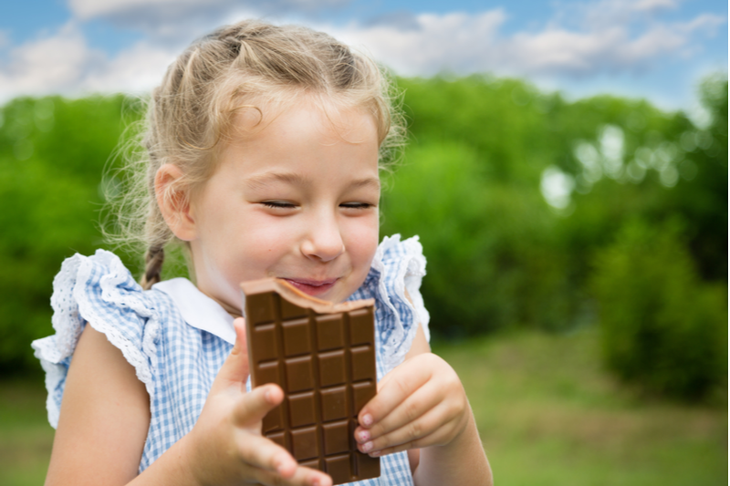 happy girl eating chocolate