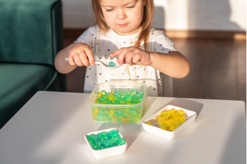 girl plays with sensory box