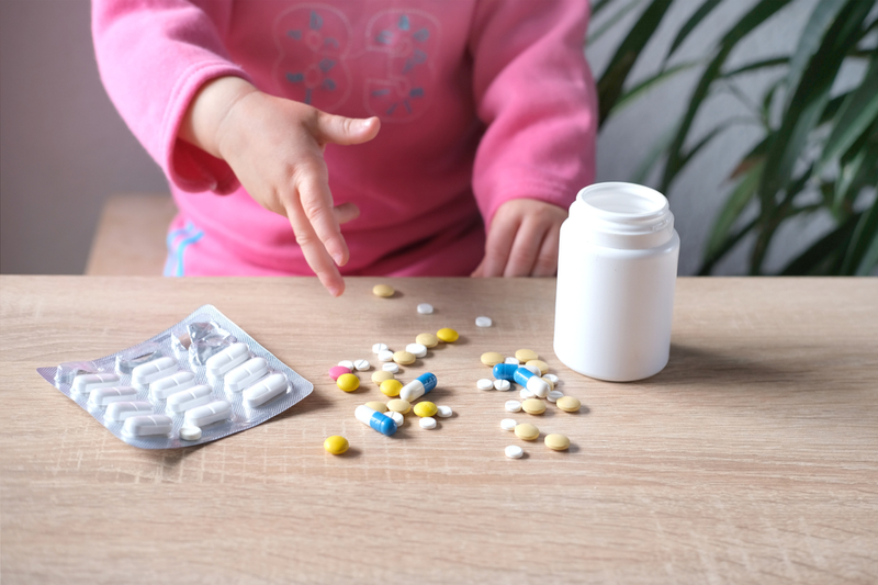 child plays with pills