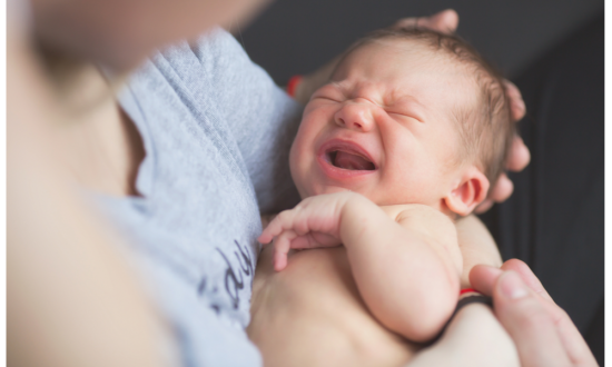 newborn cries in mothers arms