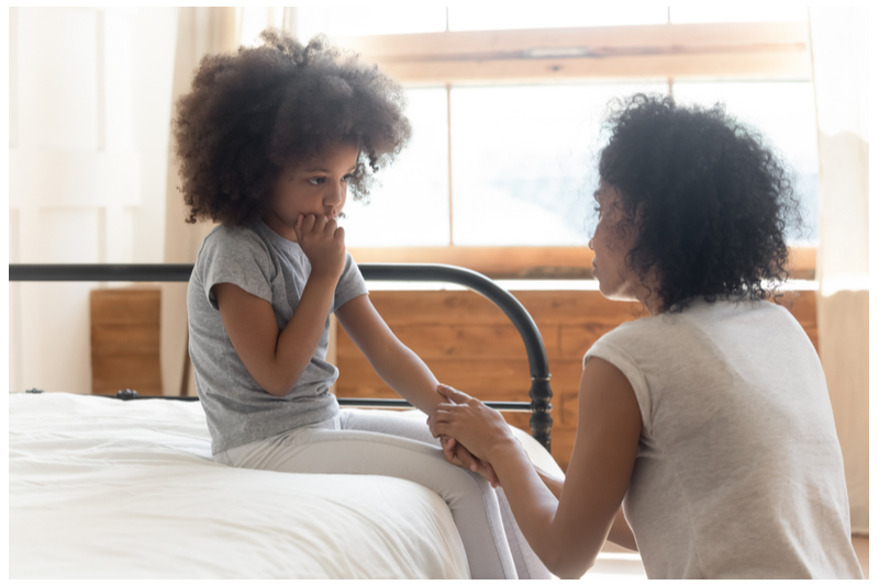 mother comforts unhappy confused child