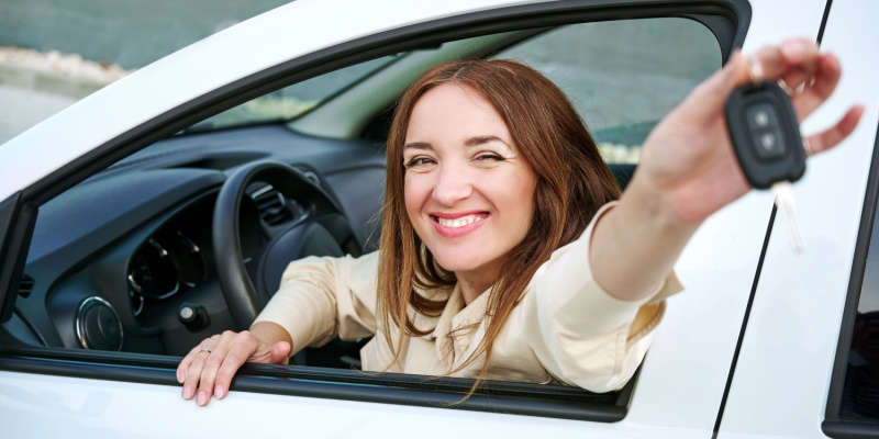 Smiling teen holds car keys